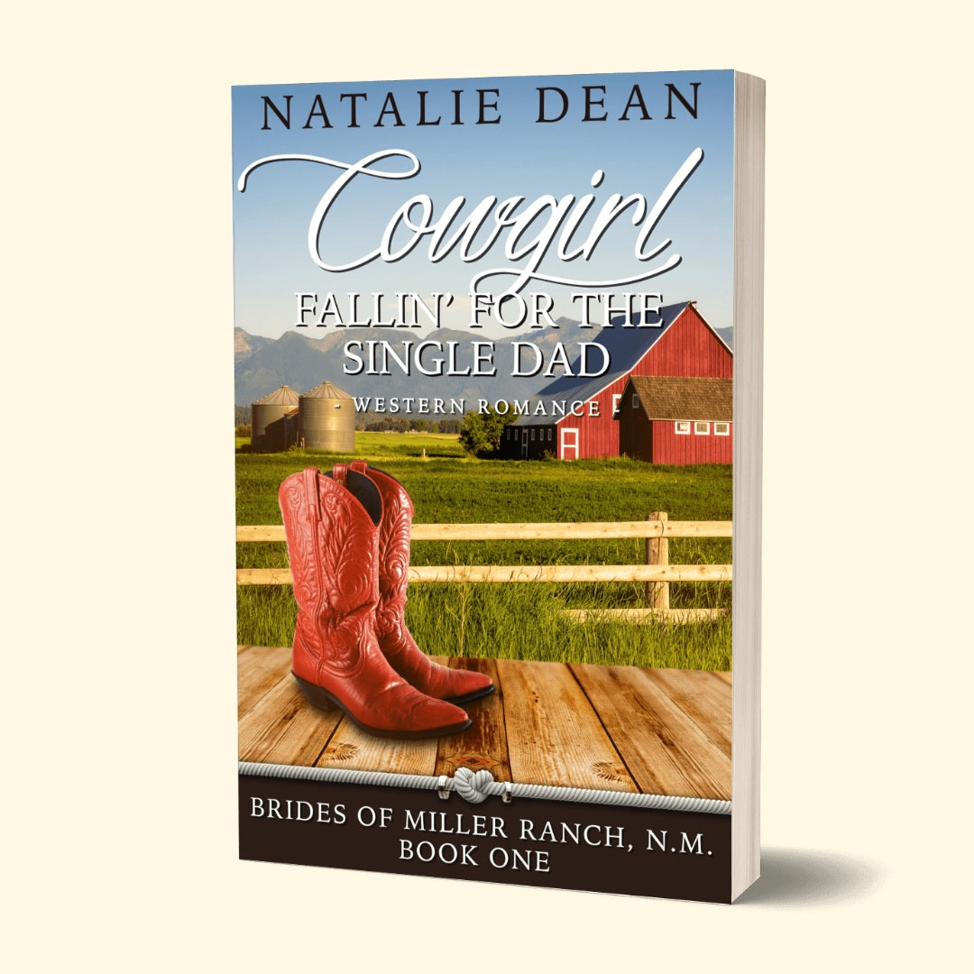 Paperback book mockup of Cowgirl Fallin’ for the Single Dad, Brides of Miller Ranch, N.M. Book one by Natalie Dean, a western romance; pair of cowgirl boots, barn and field in background