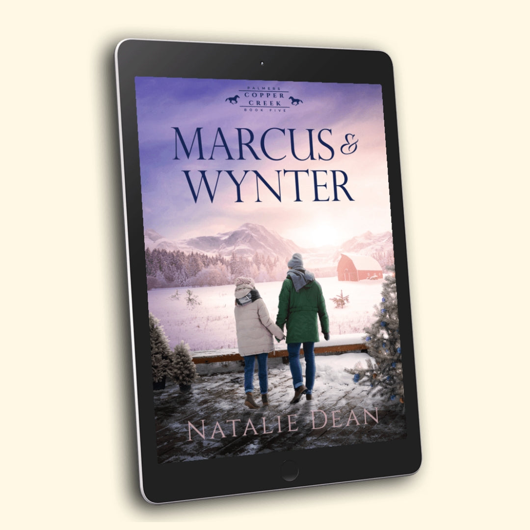 “Marcus & Wynter” by Natalie Dean—winter romance cover showing a couple in coats holding hands on a snowy Copper Creek ranch, red barn, mountains, and a lit Christmas tree.
