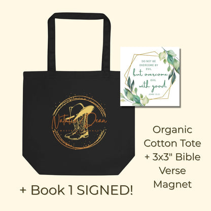 Black organic cotton tote bag with the Natalie Dean cowboy hat and boots logo, and a Bible verse magnet (John 12:21). Text states that book 1 is signed. 